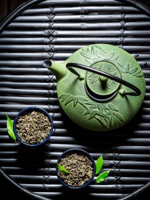 Closeup of green tea in teacup on black bamboo table Special Green Tea 50 Tea Bags (Plain)